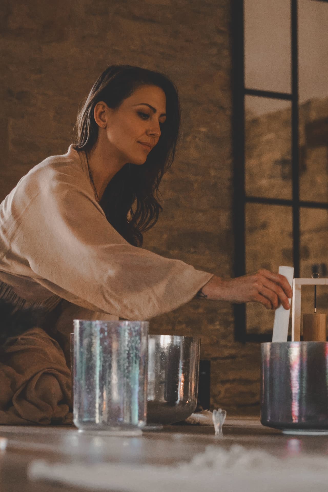 Georgia Kate Allen facilitating a sound healing session with crystal singing bowls